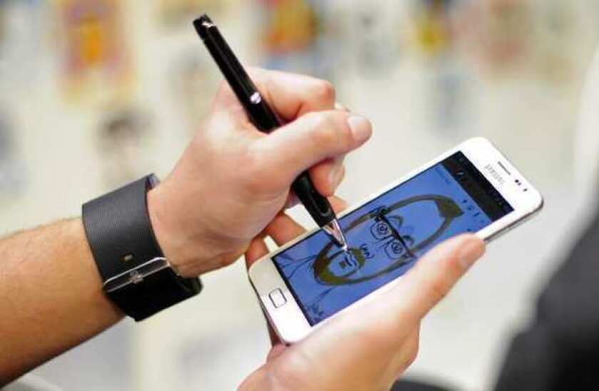 A man uses a Samsung Galaxy Note to draw a picture at the Mobile World Congress in Barcelona.