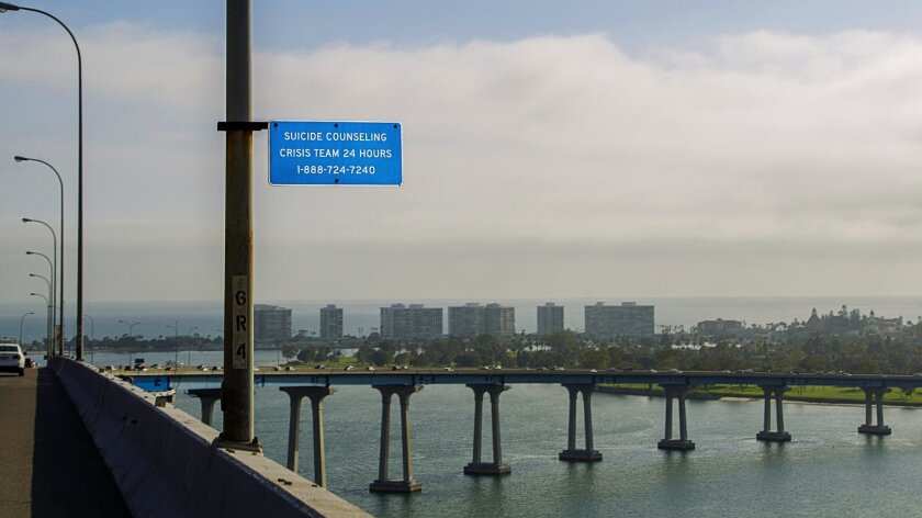 The phone number for San Diego County's Access and Crisis Line can be seen on signs along the Coronado bridge.