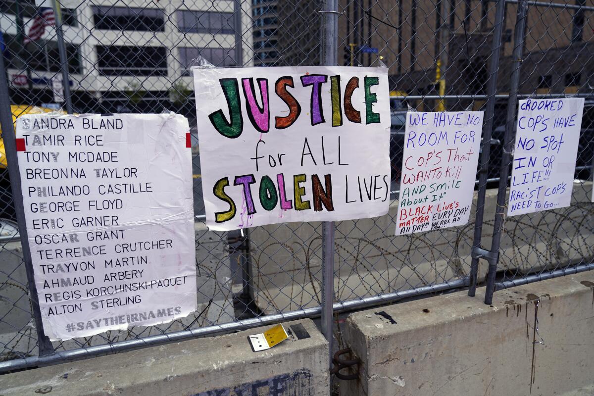 Signs on a fence at the Hennepin County Government Center