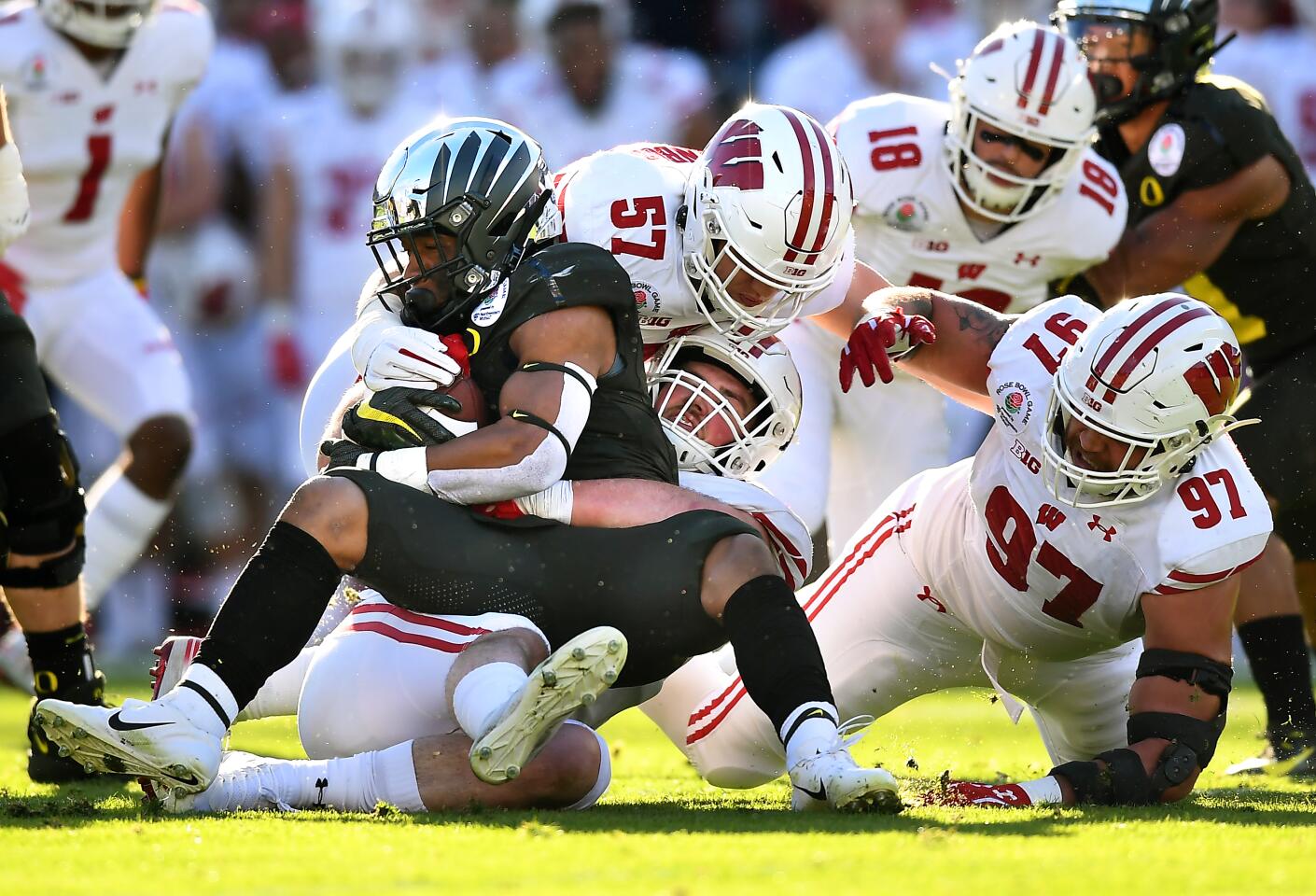 Oregon running back CJ Verdell is stopped by the Wisconsin defense in the first quarter at the Rose Bowl.