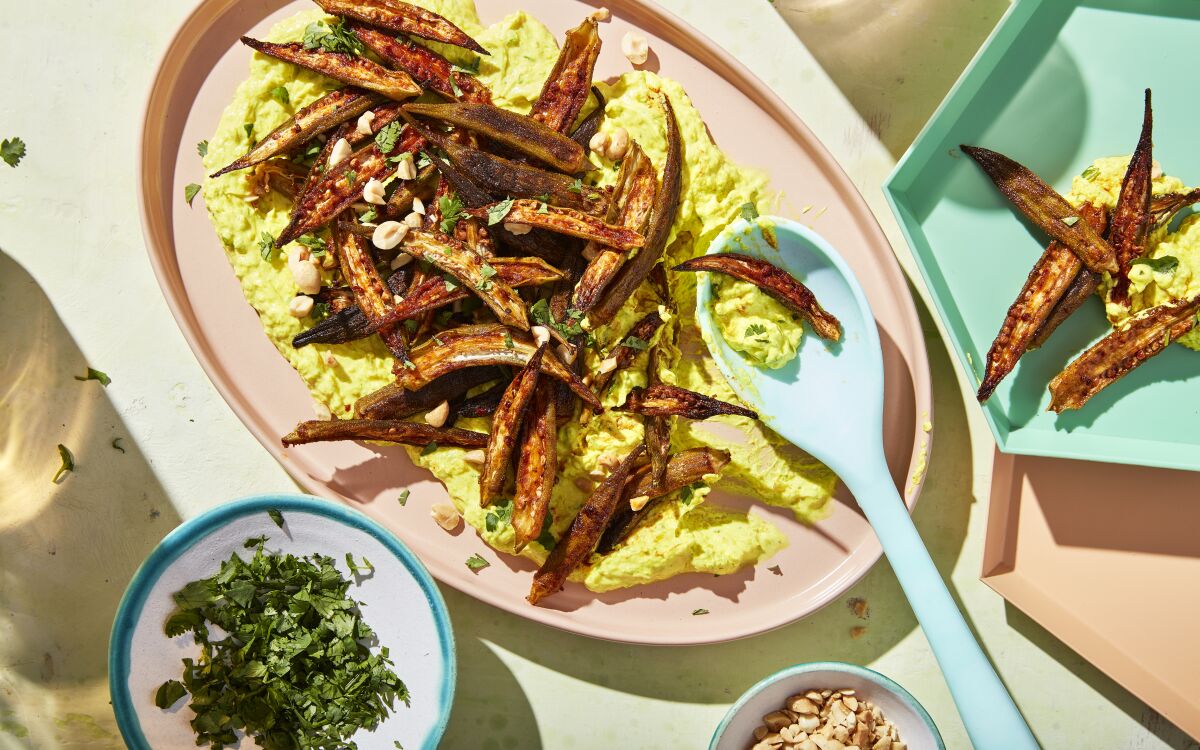 Sugar and spices add flavor to crispy roast okra served over a bed of labneh spiced with turmeric, chiles, garlic and ginger.