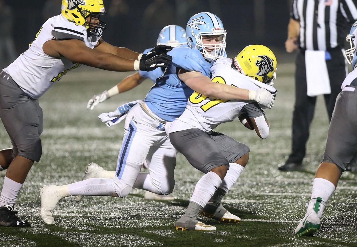 Corona del Mar's Conner Brooks tackles Cajon running back Freddy Fletcher for a loss during the quarterfinals of the CIF Southern Section Division 3 playoffs on Saturday.