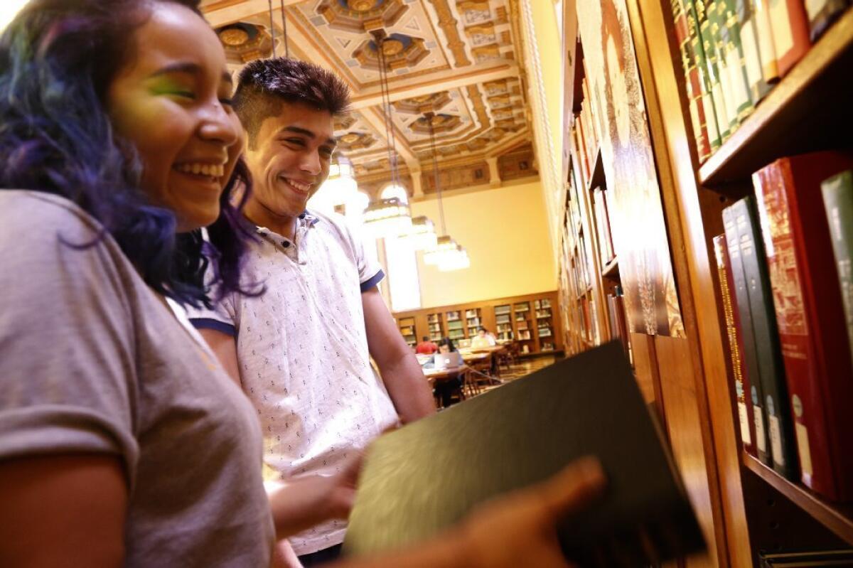 Victoria Perez, left, and Isaac Lemus explore Doheny Memorial Library at USC. Both freshmen are the first in their families to attend a four-year college.