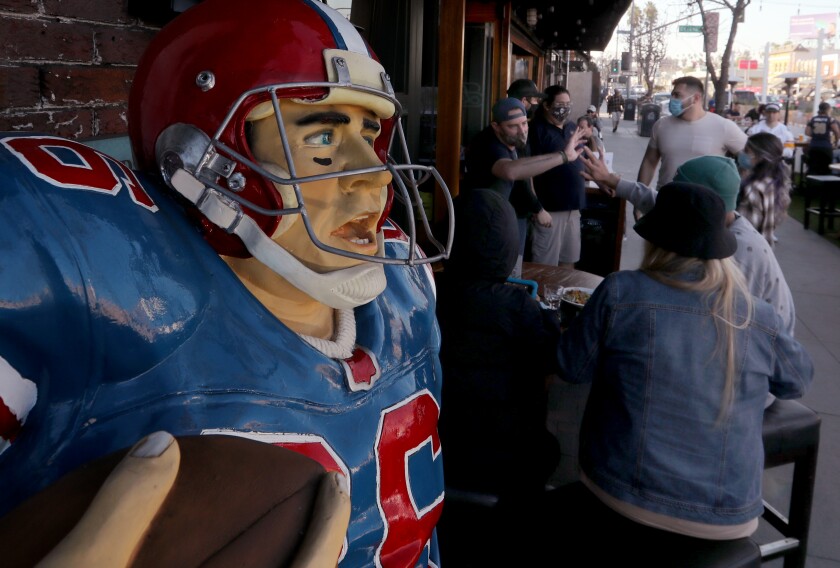 Football fans gather at Legends Restaurant & Sports Bar in Long Beach on Sunday to watch the Super Bowl telecast. 