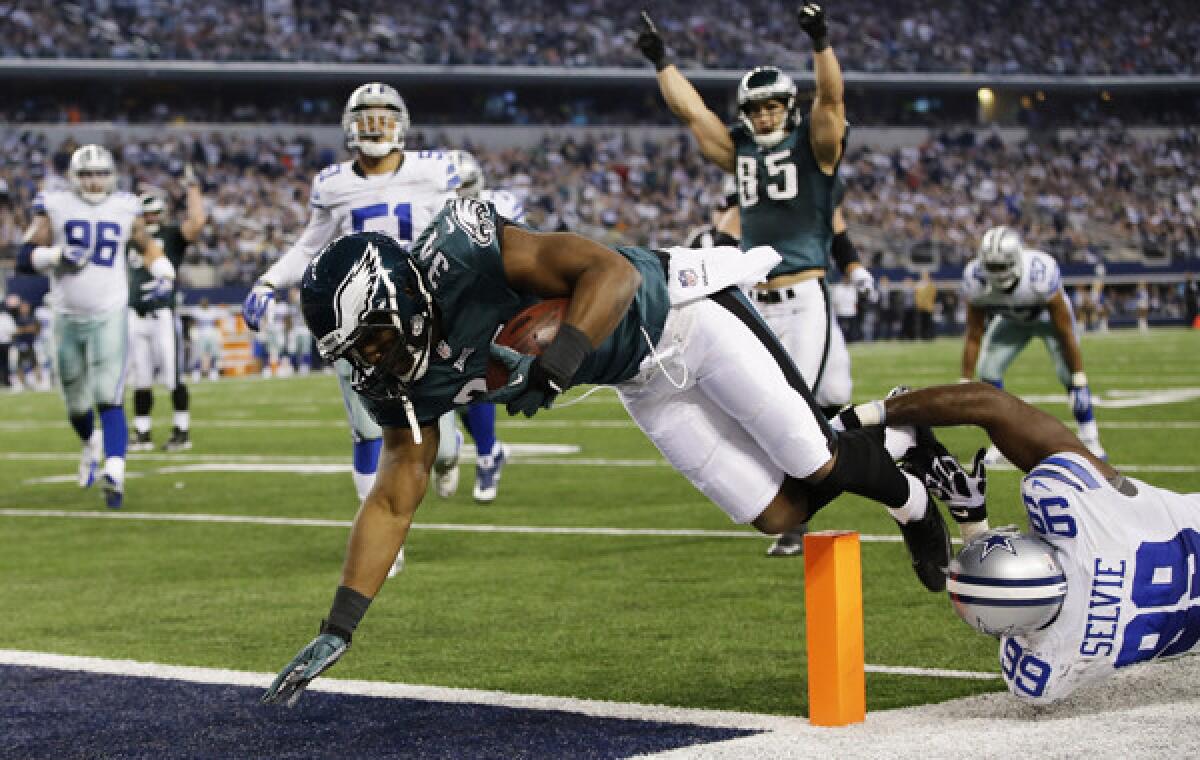Philadelphia running back Bryce Brown leaps into the end zone for a touchdown ahead of Dallas Cowboys defensive end George Selvie during the second half of the Eagles' 24-22 win Sunday.