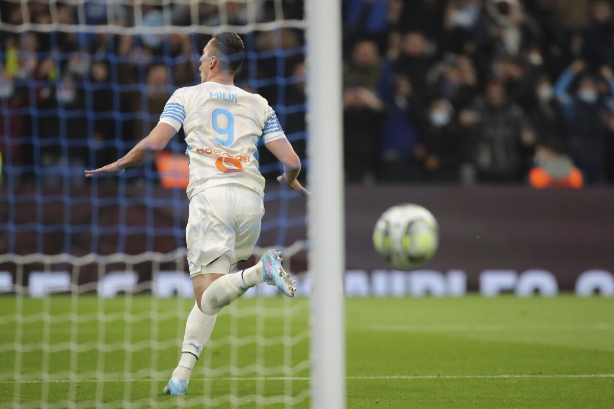 Marseille's Arkadiusz Milik celebrates after scores his third goal against Angers during the French League One soccer match between Marseille and Angers at the Stade Velodrome in Marseille, southern France, Friday, Feb. 4, 2022. (AP Photo/Daniel Cole)