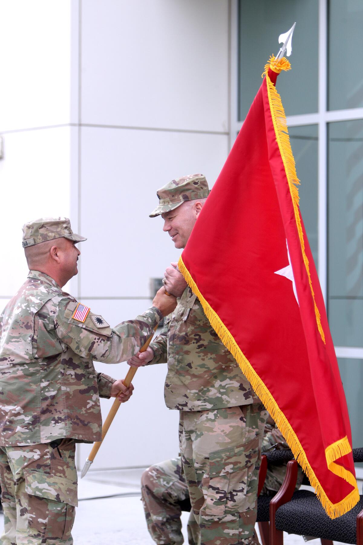 Newly promoted Brigadier General Nick Ducich receives his officer's flag during the ceremony.