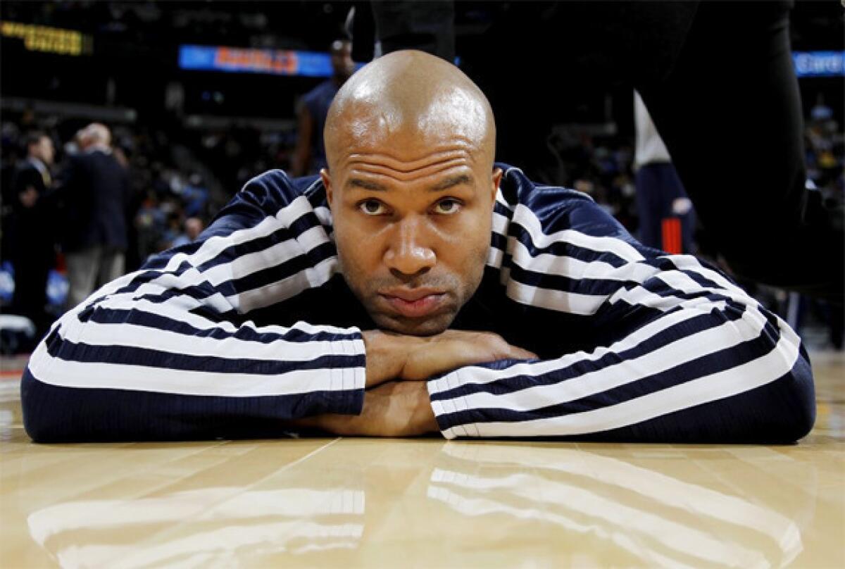 Derek Fisher waits to be stretched before an Oklahoma City Thunder game last year.