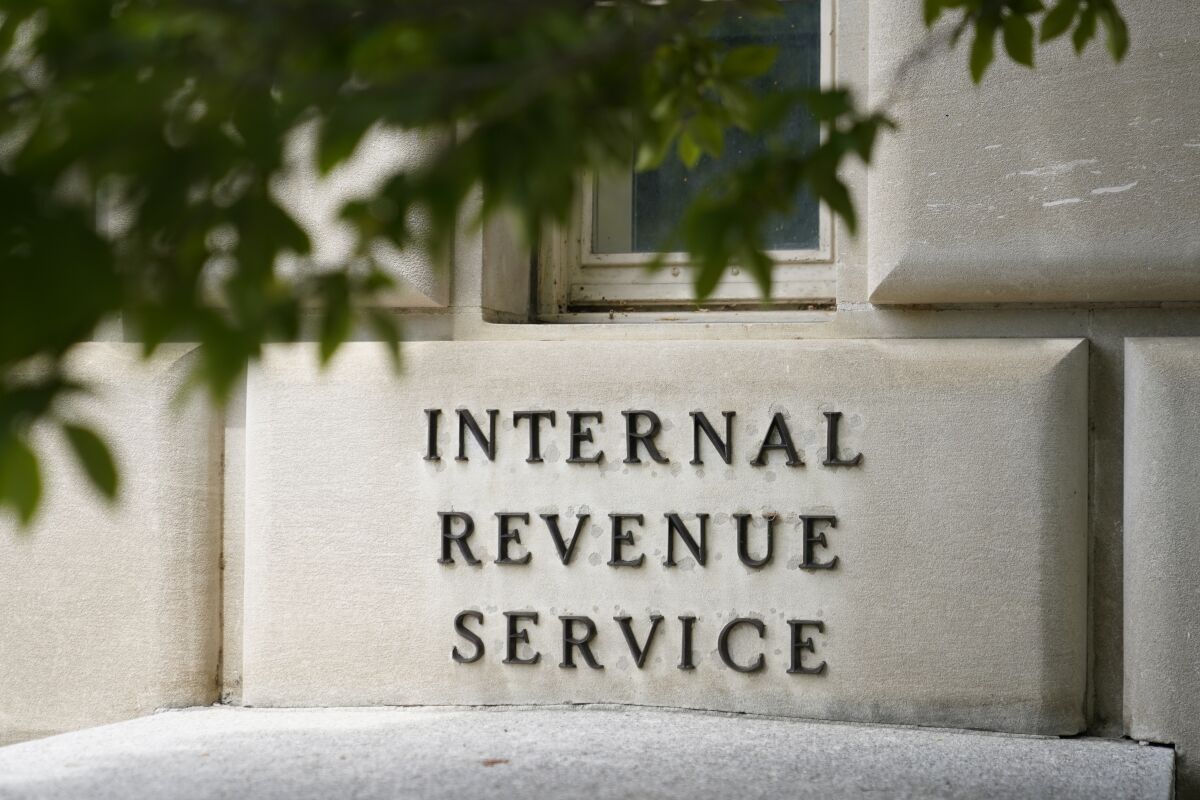 FILE - A sign hangs outside the Internal Revenue Service building in Washington, on May 4, 2021. The IRS issued guidance Friday, Feb. 3, 2023, recommending that taxpayers hold off on filing their tax returns for 2022 if they received a special tax refund or payment from their state last year due to the agency’s uncertainty about the taxability of the payments. (AP Photo/Patrick Semansky, File)