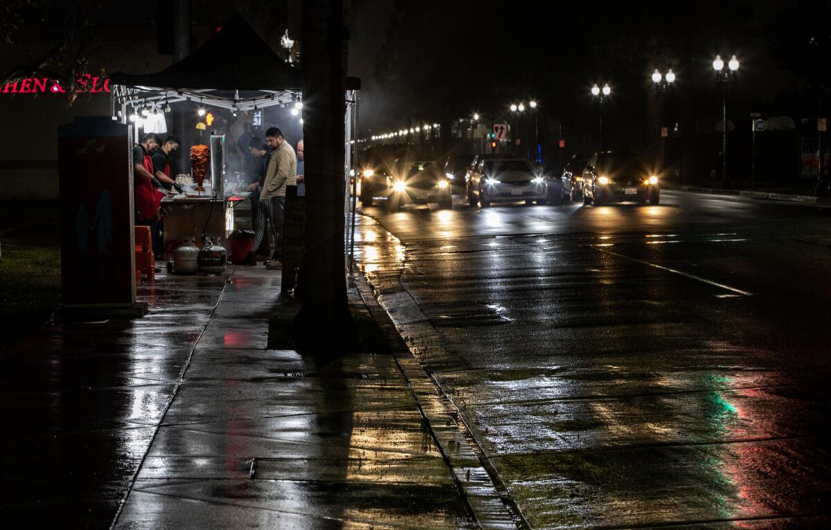 A street vendor on a rainy night