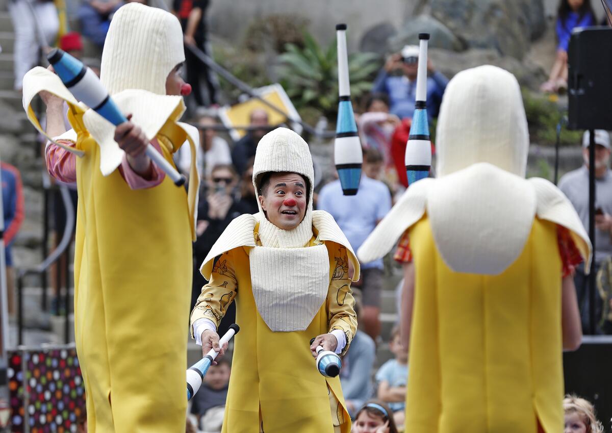 Clown jugglers dressed as bananas at Bluebird Park in Laguna Beach on Saturday.