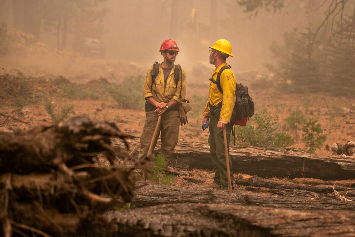 Firefighters Casey Hoffman, left, and Jeff Mabe, 