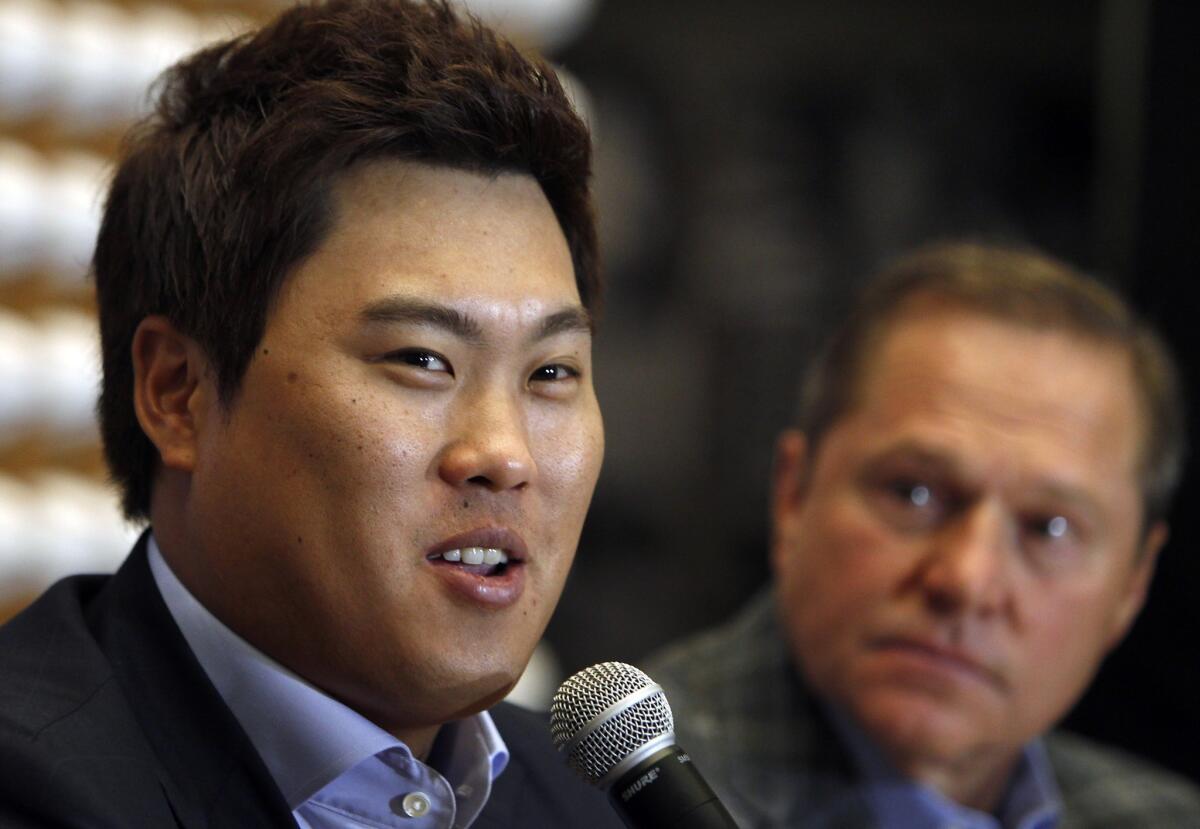 South Korea baseball pitcher Ryu Hyun-jin, left, speaks as his agent Scott Boras looks on during a baseball news conference Nov. 15 in Newport Beach.