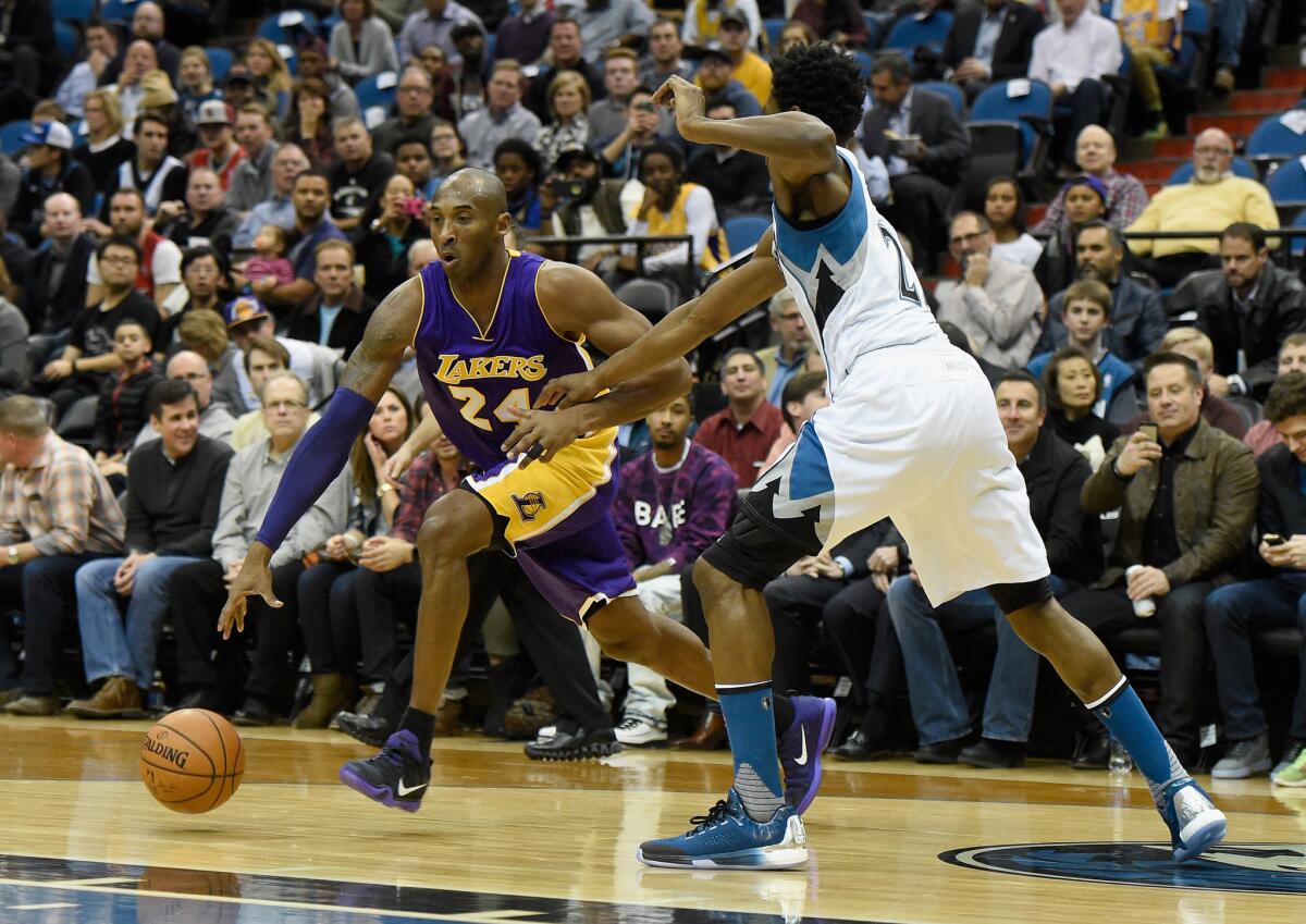 Lakers forward Kobe Bryant drives toward the basket against Timberwolves forward Andrew Wiggins during the first quarter of Wednesday's game in Minneapolis.