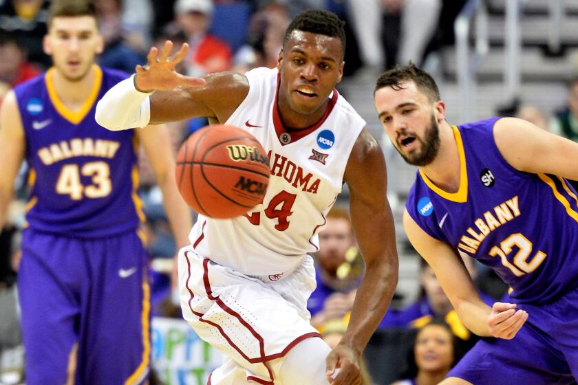 Oklahoma guard Buddy Hield steals the ball in front of Albany guard Peter Hooley during the Sooners' 69-69 victory over the Great Danes on Friday. at Nationwide Arena in Columbus, Ohio.