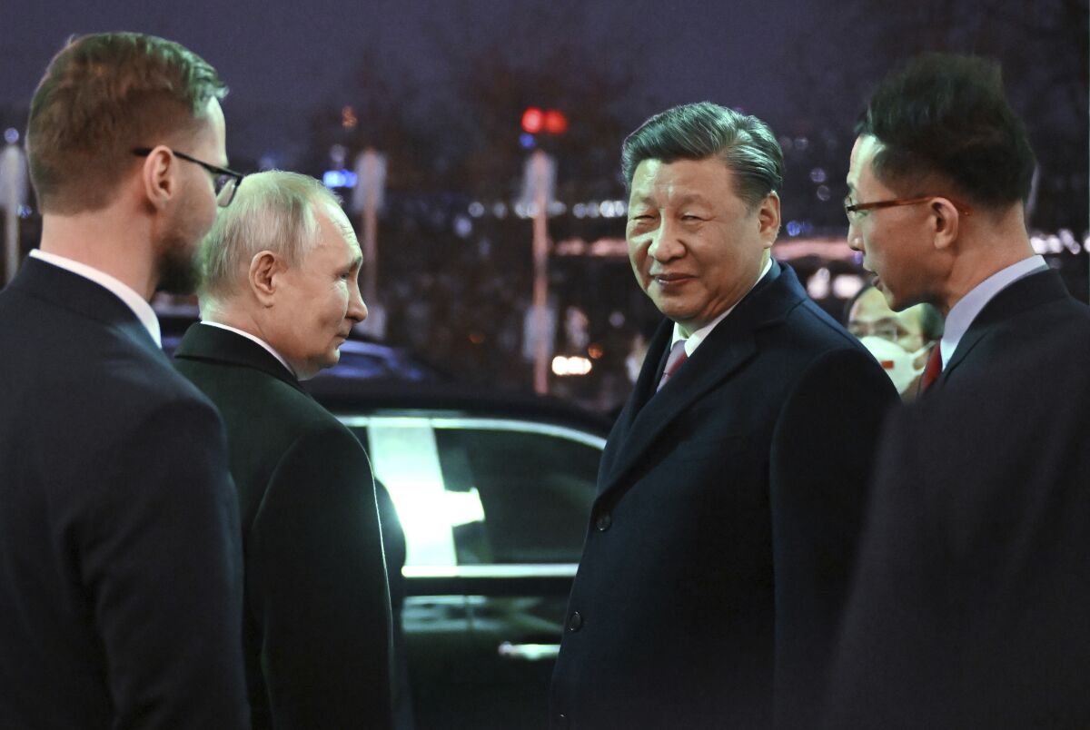 Chinese President Xi Jinping, right, and Russian President Vladimir Putin talk to each other prior to Chinese President Xi Jinping leaving after their dinner at The Palace of the Facets in the Moscow Kremlin, Russia, Tuesday, March 21, 2023. (Grigory Sysoyev, Sputnik, Kremlin Pool Photo via AP)