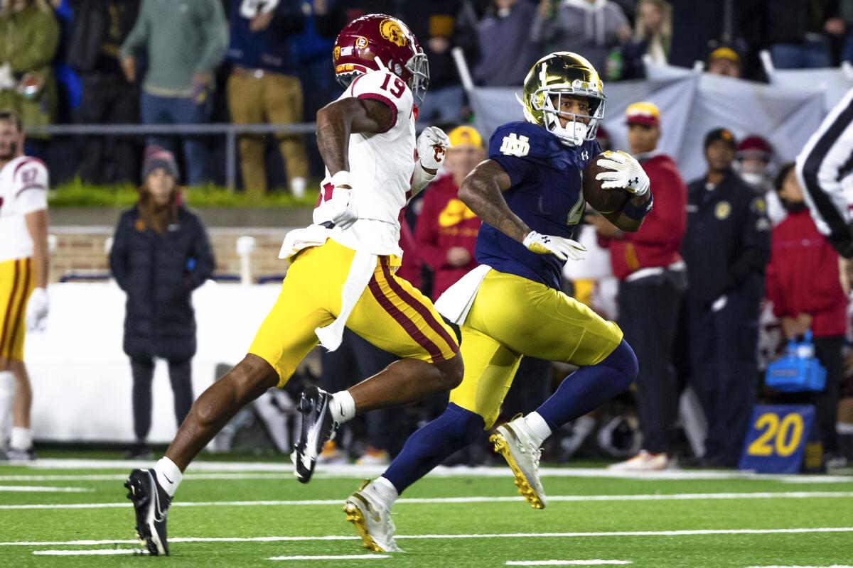 Notre Dame wide receiver Chris Tyree runs for a touchdown in front of USC safety Jaylin Smith.