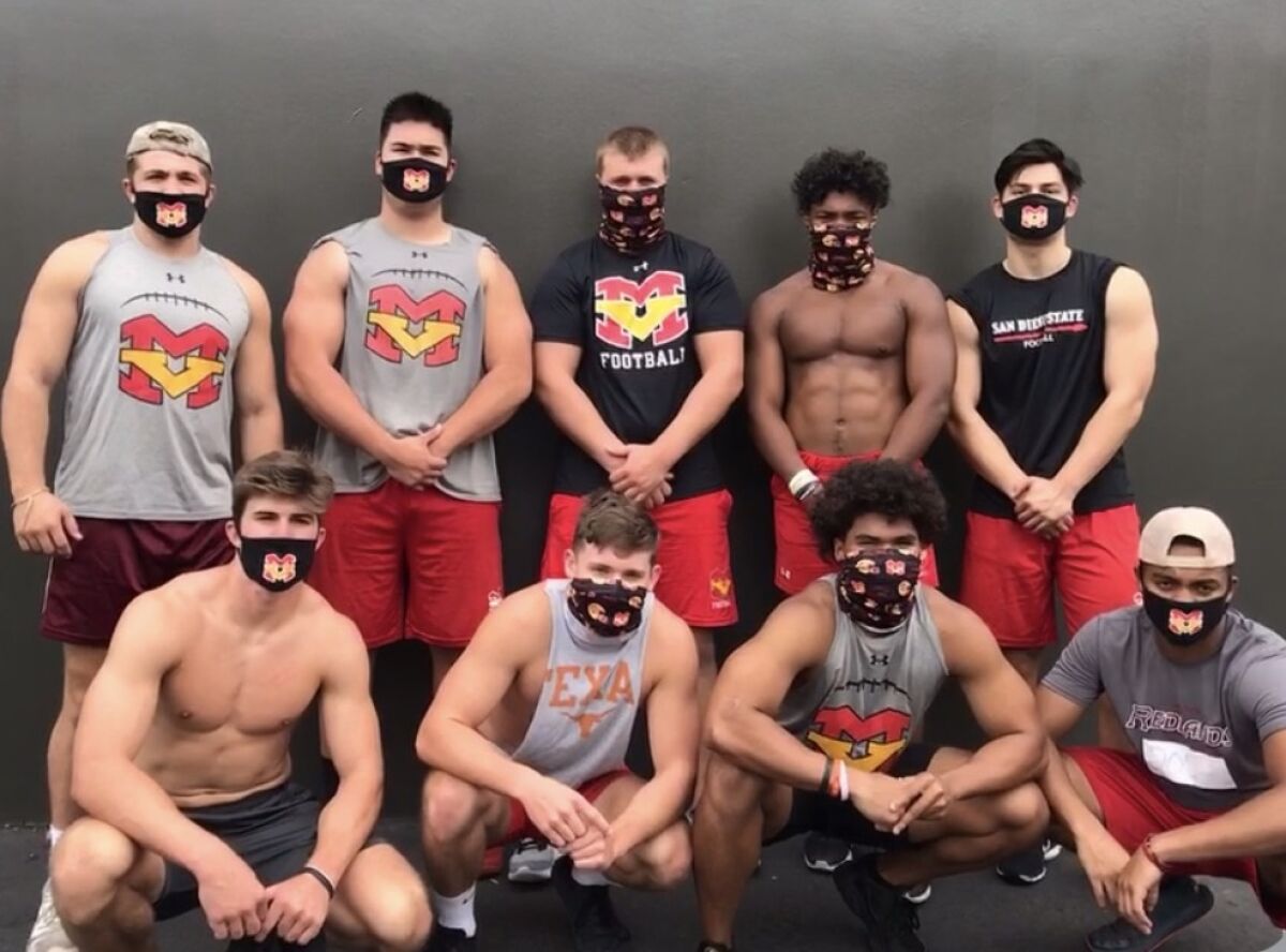Mission Viejo football players wear their customized Mission Viejo masks.