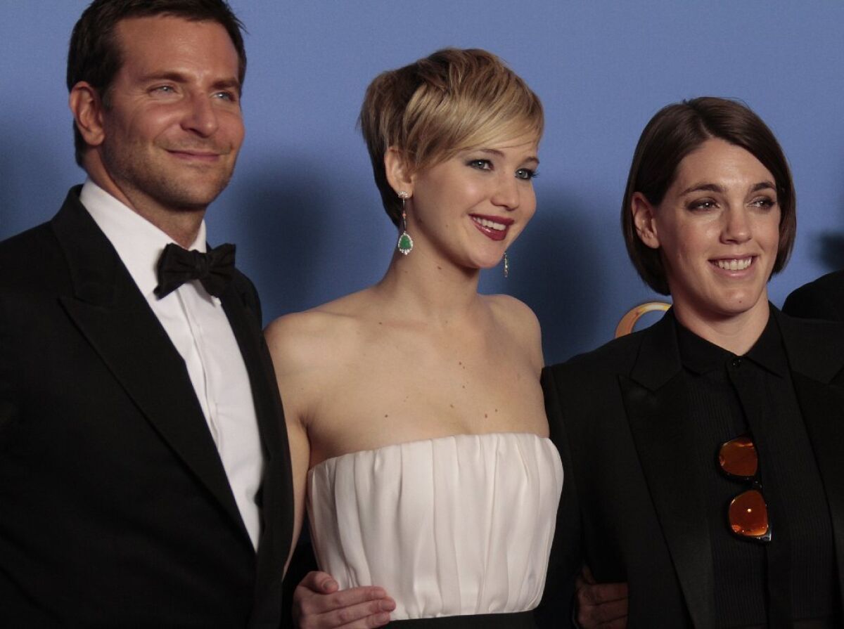 Bradley Cooper, Jennifer Lawrence and Megan Ellison at the Golden Globe Awards show at the Beverly Hilton Hotel in 2014.