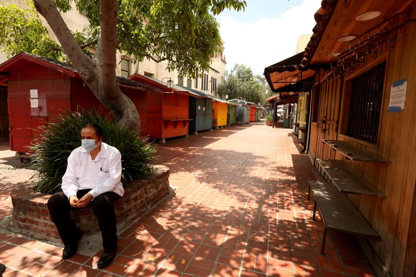 LOS ANGELES, CA - MAY 13, 2020 - - "We're talking about no business," said Guillermo Garcia, 61, as he looks back at an empty and shuttered Olvera Street in El Pueblo de Los Angeles on May 13, 2020. Garcia owns the restaurant, La Noche Buena," and the store, "Memo's Place," on Olvera Street and has worked there for the past 48 years. His restaurant La Noche Buena is still open for take-out. Merchants on the historic street are currently unable to operate and do not now when they'll be able to reopen. They're asking the city for rent forgiveness between April through the city's final phase of reopening, including six months after that so that they can get back up on their feet. (Genaro Molina / Los Angeles Times)