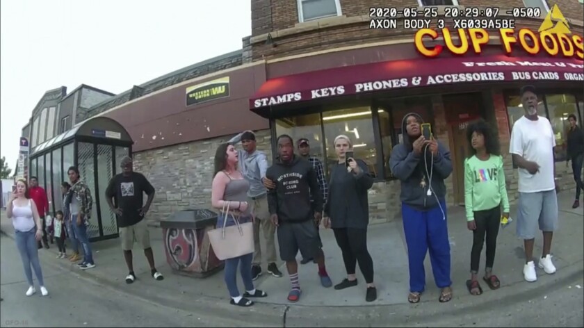 FILE - In this image from a police body camera, bystanders, including Alyssa Funari, filming at left; Charles McMillan, center left in light colored shorts; Christopher Martin, center in gray, with hand on head; Donald Williams, center in shorts; Genevieve Hansen, filming, fourth from right; Darnella Frazier, filming, third from right, witness as then Minneapolis police officer Derek Chauvin pressed his knee on George Floyd's neck for several minutes, killing Floyd on May 25, 2020, in Minneapolis. Frazier, who recorded the widely seen video of Floyd’s killing, began crying Monday, Feb. 14, as she started testifying in the federal trial of three former Minneapolis police officers who are charged with violating the Black man’s civil rights, prompting the judge to take a quick, unexpected break. (Minneapolis Police Department via AP, File)