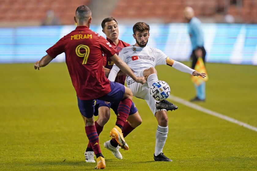Real Salt Lake's Justin Meram (9) and Donny Toia, rear, defend against Los Angeles FC forward Diego Rossi, right, during the first half of an MLS soccer match Wednesday, Sept. 9, 2020, in Sandy, Utah. (AP Photo/Rick Bowmer)