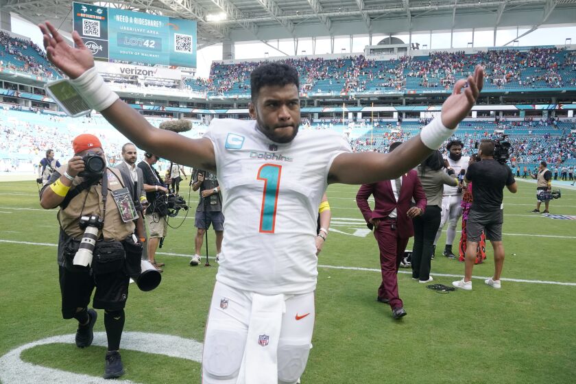 Miami Dolphins quarterback Tua Tagovailoa (1) gestures to fans at the end of an NFL football game against the Buffalo Bills, Sunday, Sept. 25, 2022, in Miami Gardens, Fla. The Dolphins defeated the Bill 21-19. (AP Photo/Wilfredo Lee )