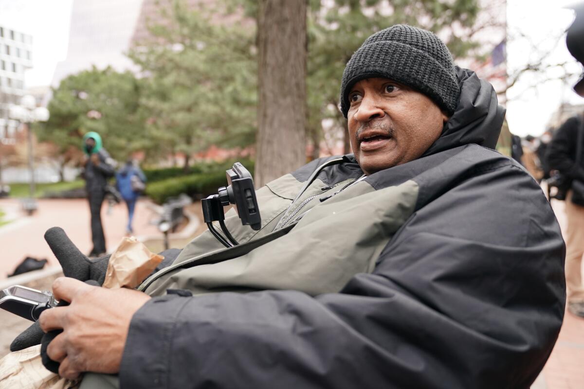 Michael Jones, 59, of Minneapolis, watches the closing arguments on the street outside the courthouse.