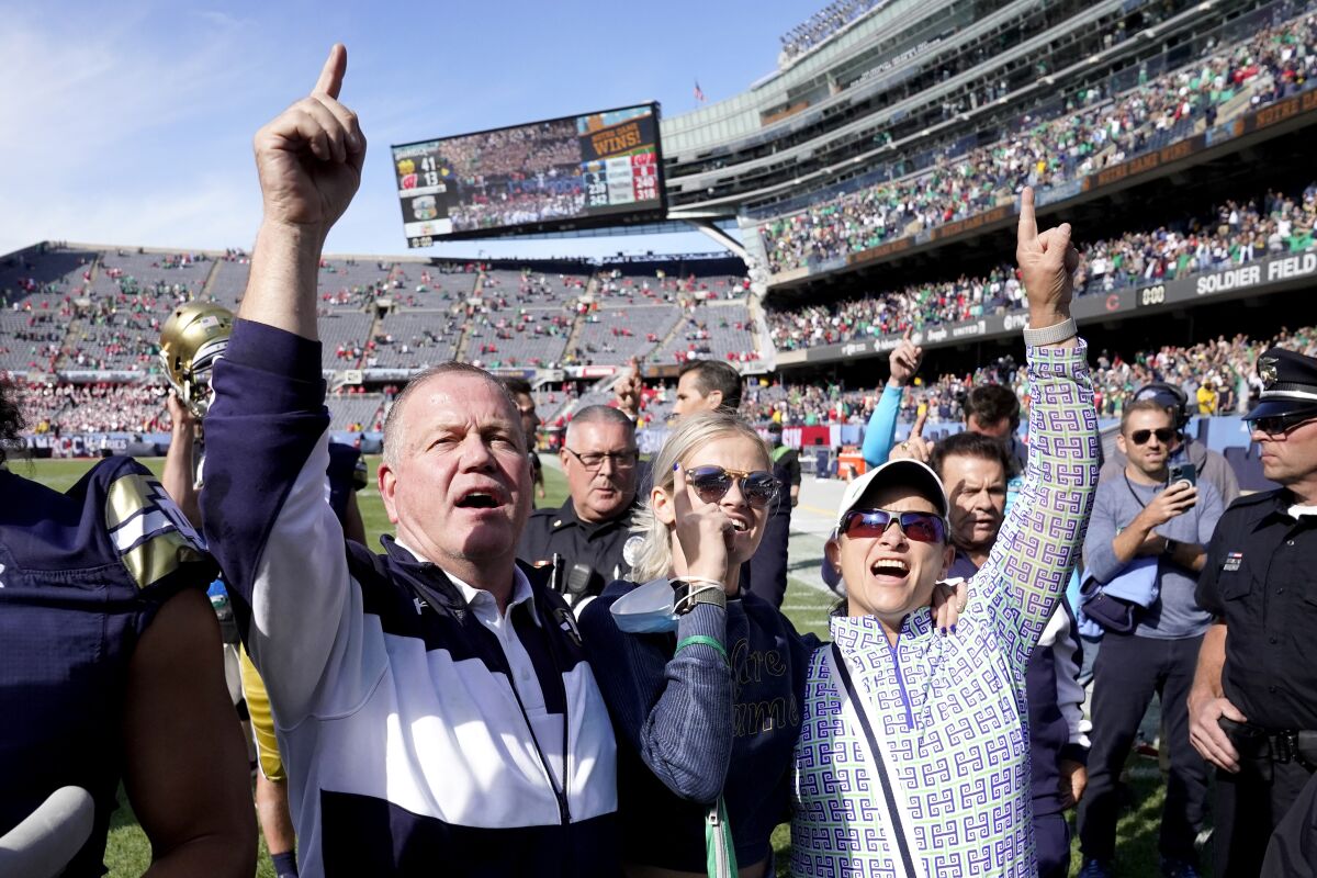 Notre Dame coach Brian Kelly, left, and his family celebrate a 41-13 win over Wisconsin on Sept. 25, 2021, in Chicago.
