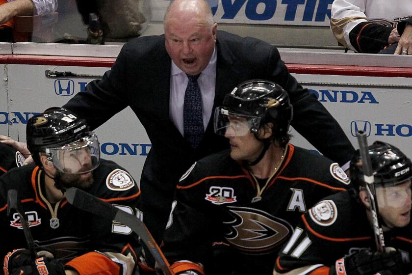 Ducks Coach Bruce Boudreau talks with his players in a game last April at the Honda Center in Anaheim.