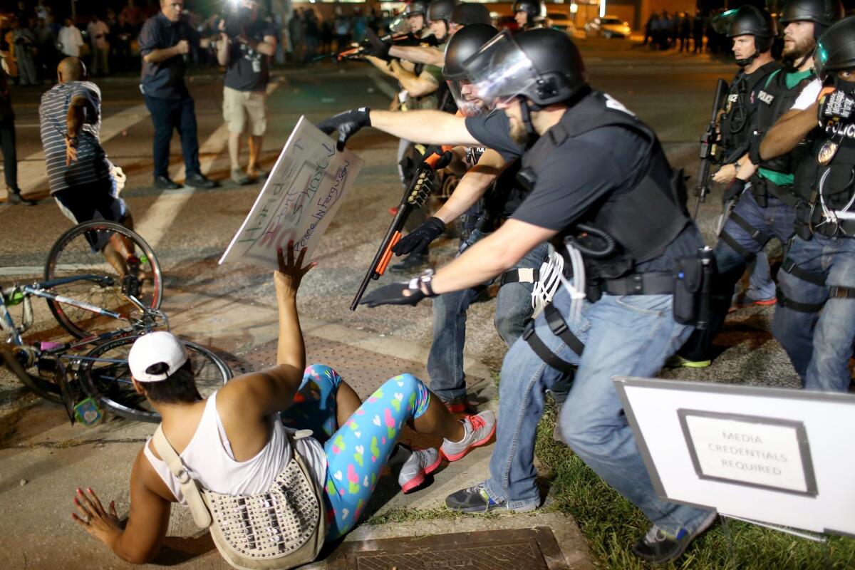 Police confront protesters in Ferguson, Mo., in the days after the August 2014 shooting death of Michael Brown.