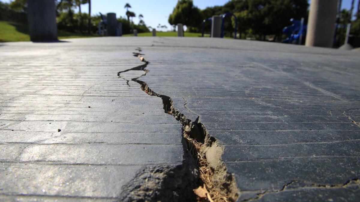A long crack splits the sidewalk at the Discovery Well Park in Huntington Beach, located on top of the Newport-Inglewood fault.