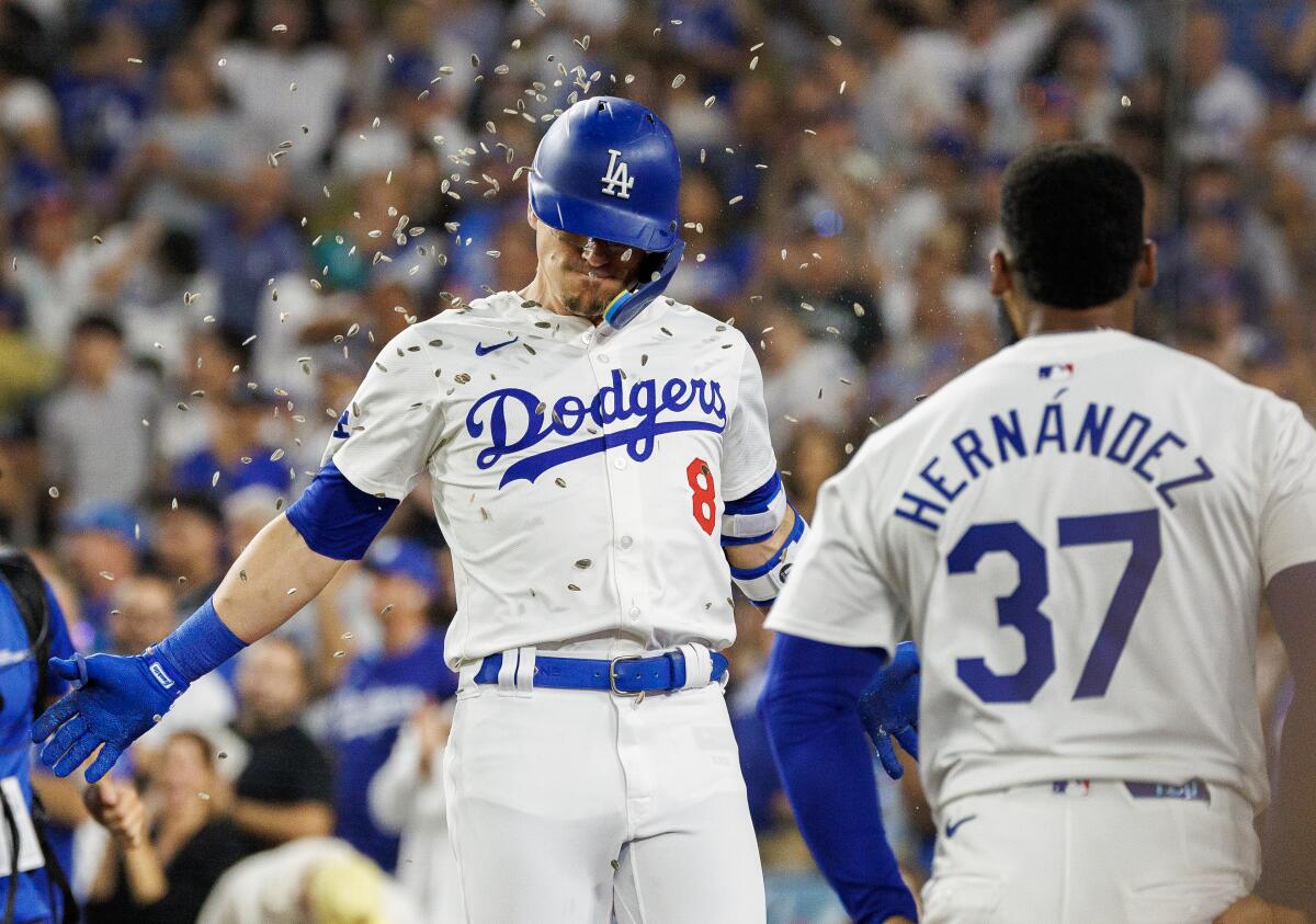 Dodgers third base Kiké Hernández gets hit with a sunflower seed shower from outfielder Teoscar Hernández 