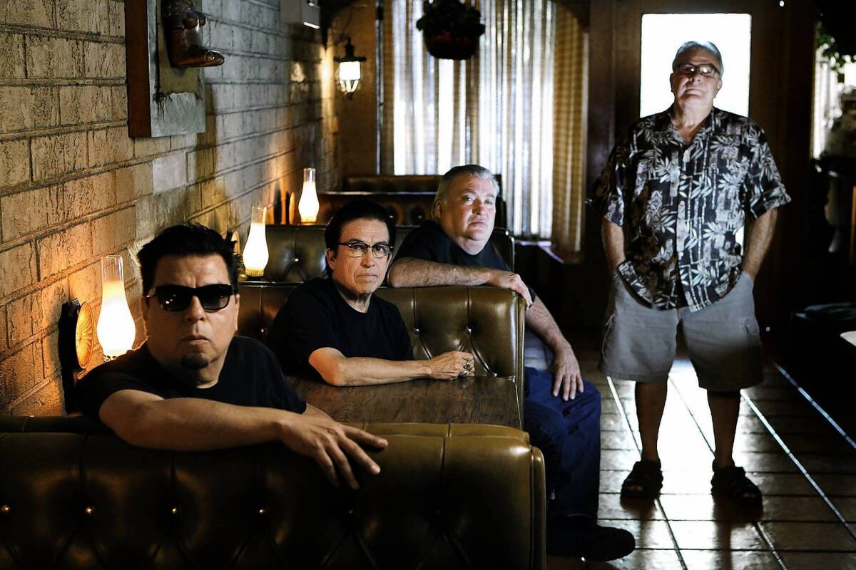 Los Lobos from left, Cesar Rosas, Louie Perez, David Hidalgo, and Conrad Lozano relax at Lucy's El Adobe Restaurant in Los Angeles.