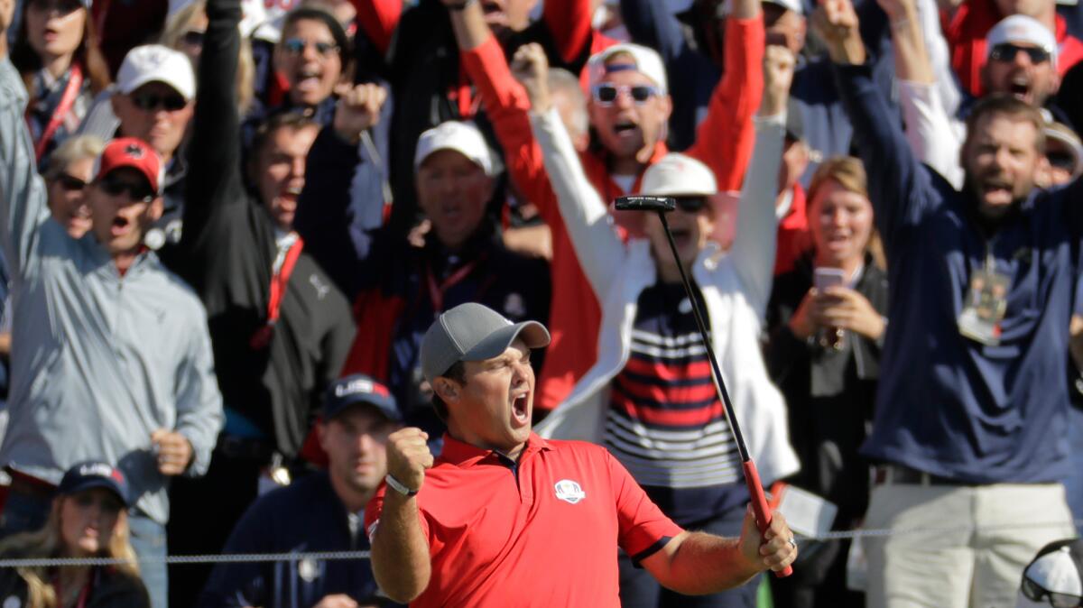 U.S. golfer Patrick Reed celebrates after making a match-winning putt during the first round of the Ryder Cup at Hazeltine National in Minnesota.