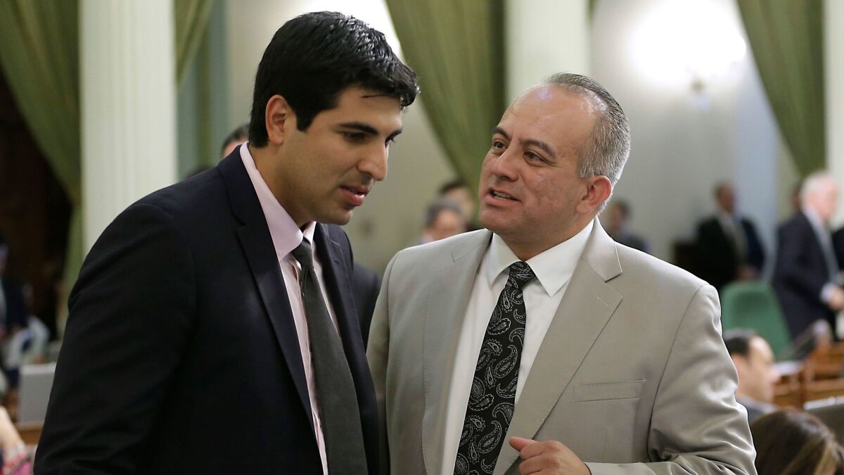Assemblyman Matt Dababneh, left, chats in 2014 with Raul Bocanegra, who resigned from the Assembly last week.