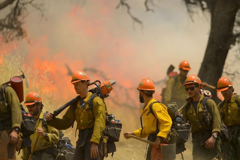 Hot Shot crews from Mendocino use backfires to help contain the County Fire along Highway 129 near Lake Berryessa in Yolo County, California, on Tuesday, July 3, 2018. (Randall Benton/The Sacramento Bee via AP)