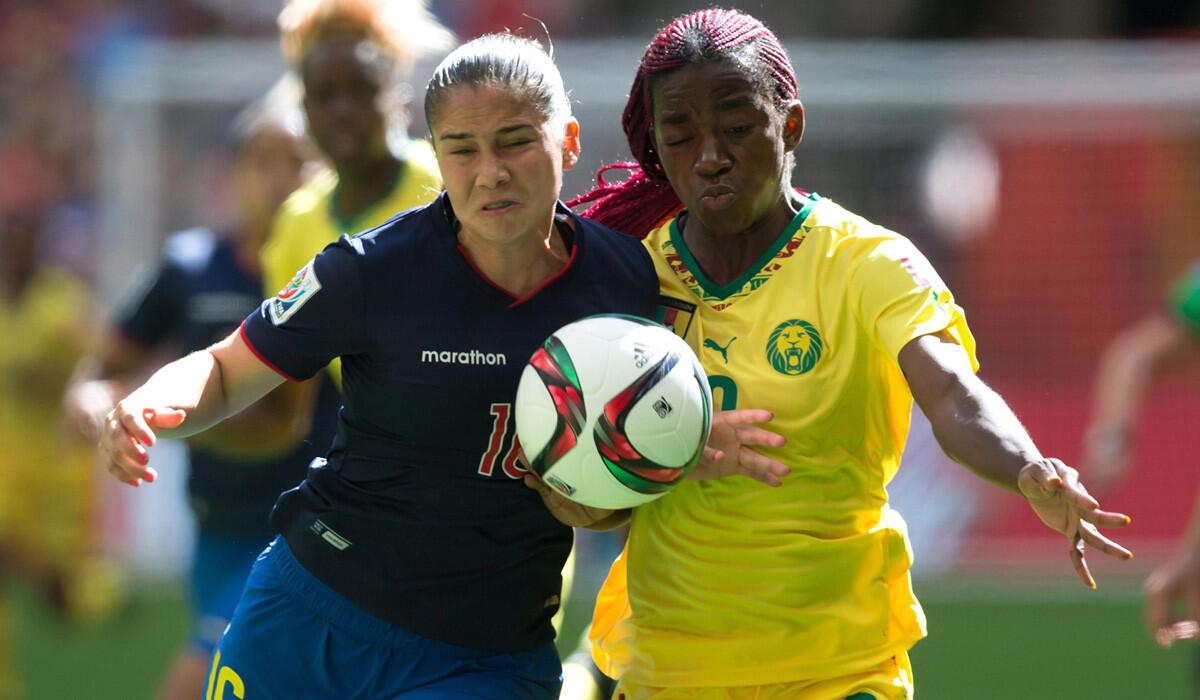 Ecuador's Ligia Moreira, left, and Cameroon's Madeleine Ngono Mani vie for the ball during the first half of a FIFA Women's World Cup soccer match on Monday.