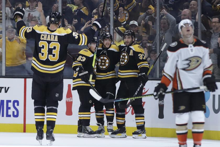 Boston Bruins defenseman Zdeno Chara (33) joins teammates Brad Marchand (63), David Pastrnak and Patrice Bergeron (37) to celebrate Pastrnak's goal as Anaheim Ducks center Derek Grant, right, reacts in the second period of an NHL hockey game, Monday, Oct. 14, 2019, in Boston. (AP Photo/Elise Amendola)