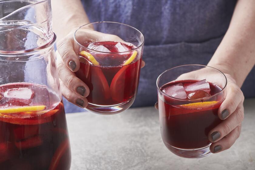 A person served chilled Red Hibiscus Mocktails.