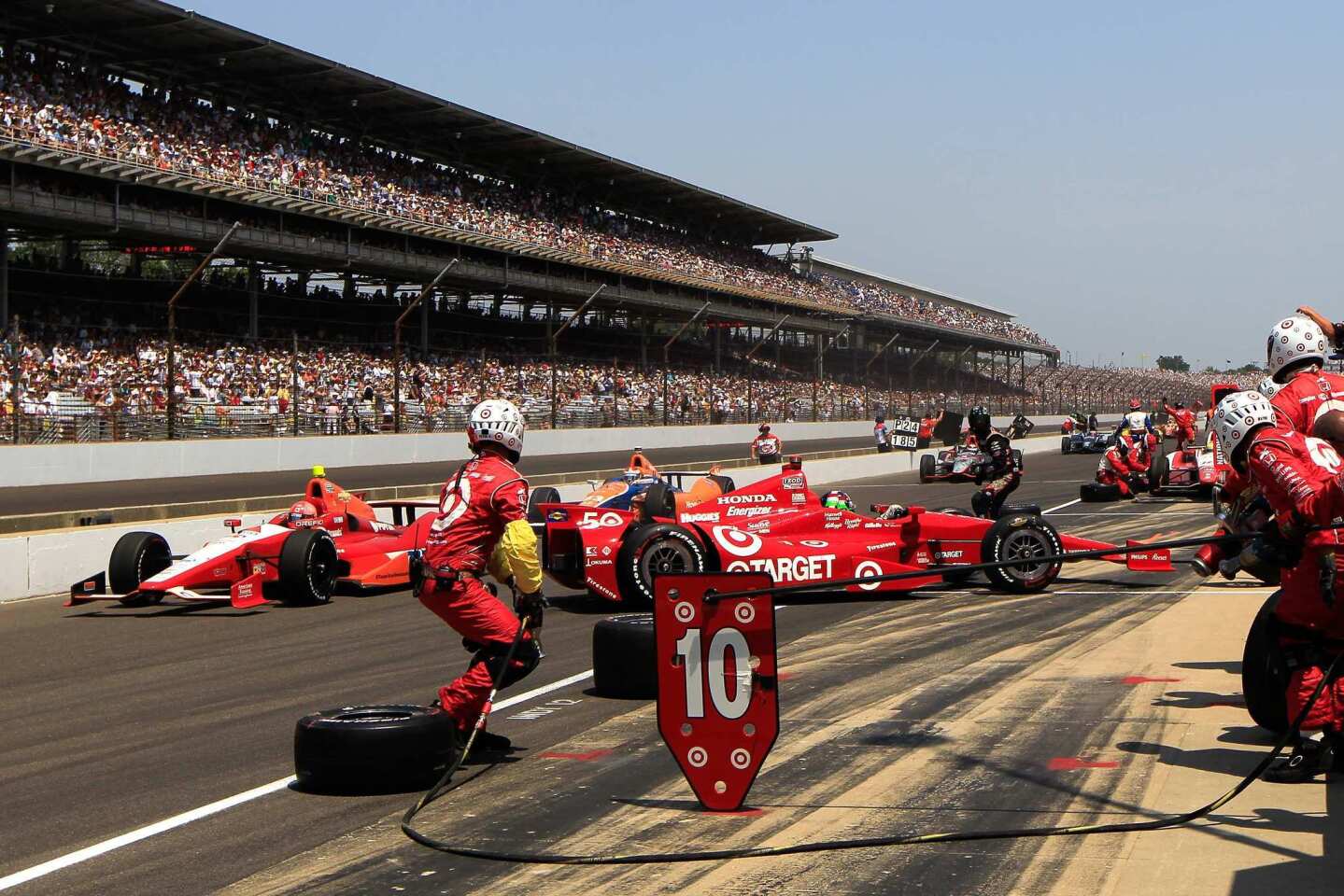 The car of Dario Franchitti is spun on pit road by E.J. Viso during a stop on Sunday in the 96th Indianapolis 500.