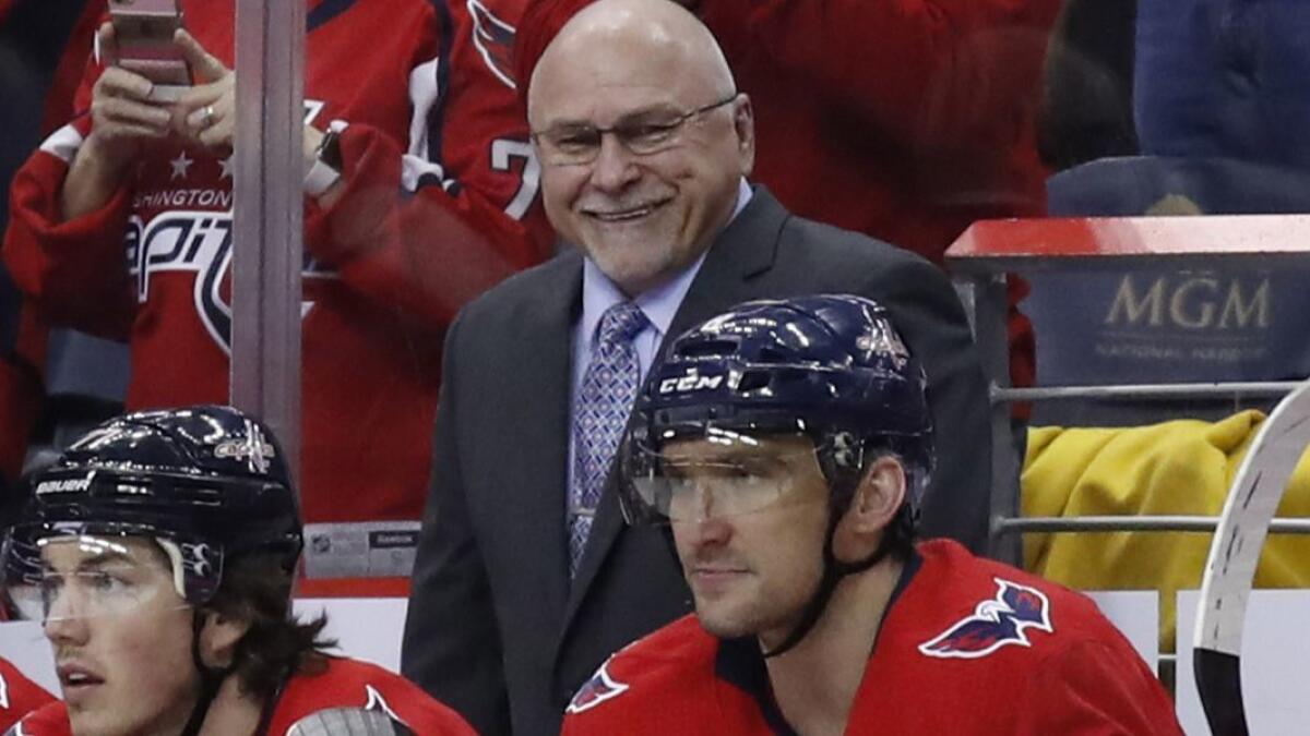 Washington Capitals coach Barry Trotz smiles after left wing Alex Ovechkin, right, scored a goal in a March 12 game against the Winnipeg Jets in Washington.