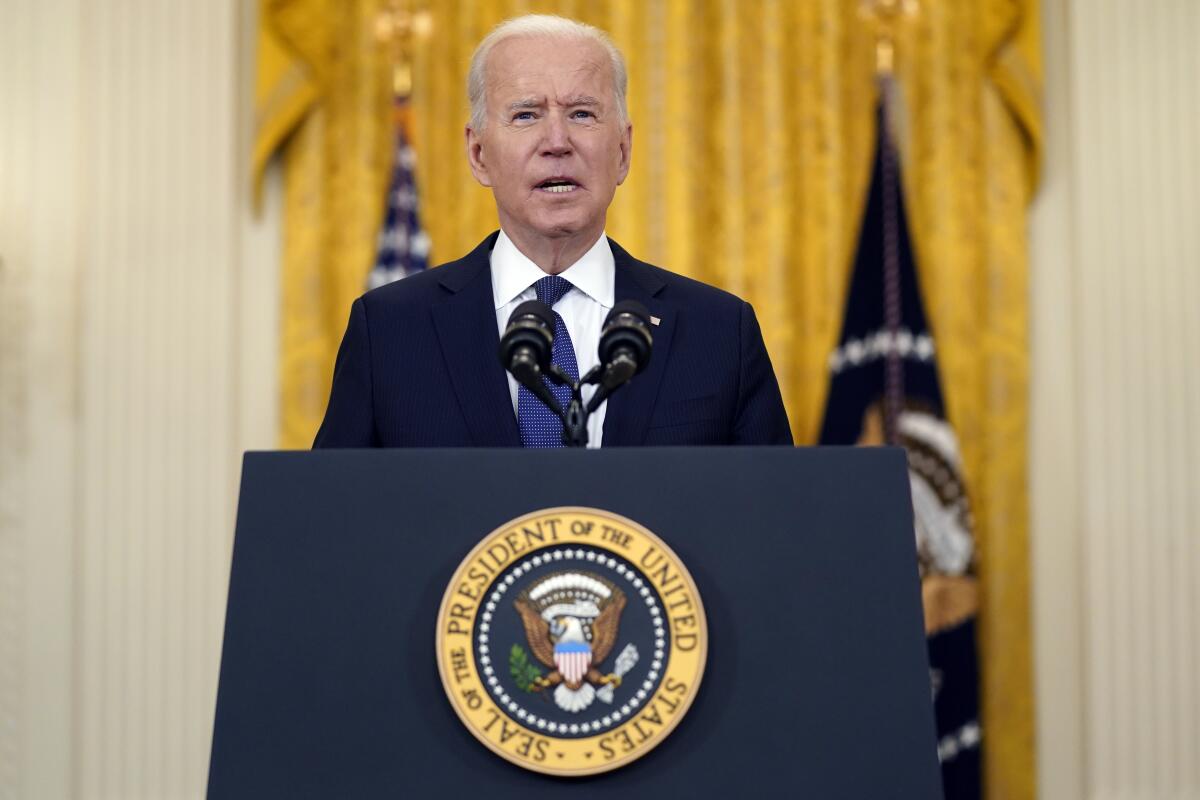 President Biden speaks at a lectern.