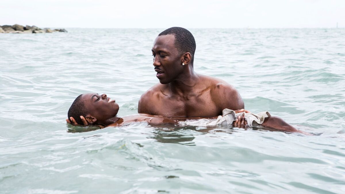 This image released by A24 Films shows Alex Hibbert, left, and Mahershala Ali in a scene from the film, "Moonlight."