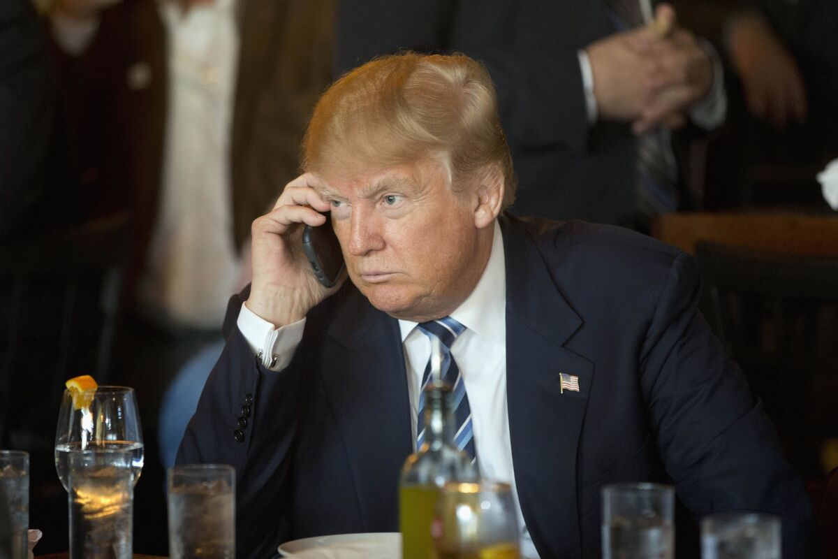 Donald Trump on his phone, a Samsung Galaxy, during a campaign stop in February.