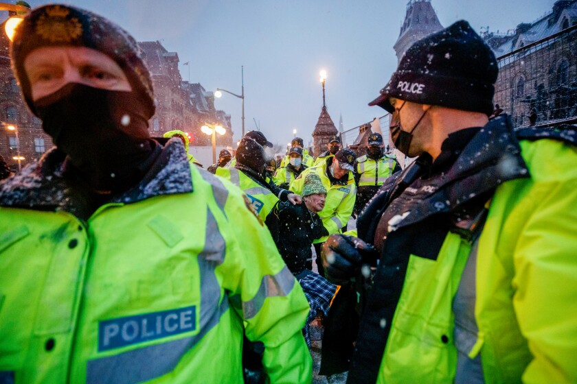 Police arresting a protester in Ottawa.