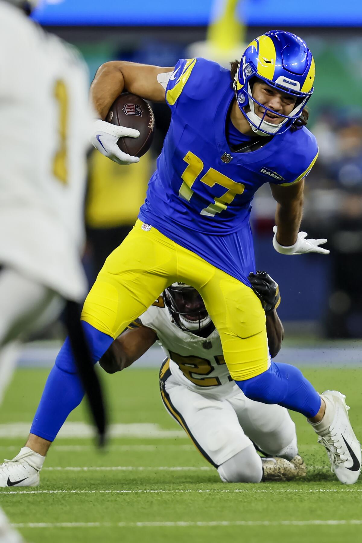 Rams wide receiver Puka Nacua breaks a tackle against the Saints.