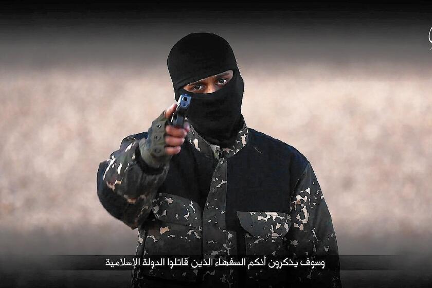 A militant known as the "new Jihadi John" is seen in an image taken from an Islamic State execution video.