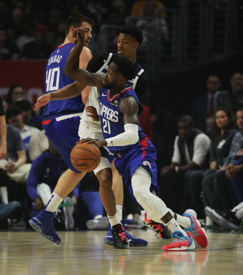Clippers guard Patrick Beverley slips Timberwolves guard Jarrett Culver (23) behind a screen during the first half of a game Feb. 1 at Staples Center.