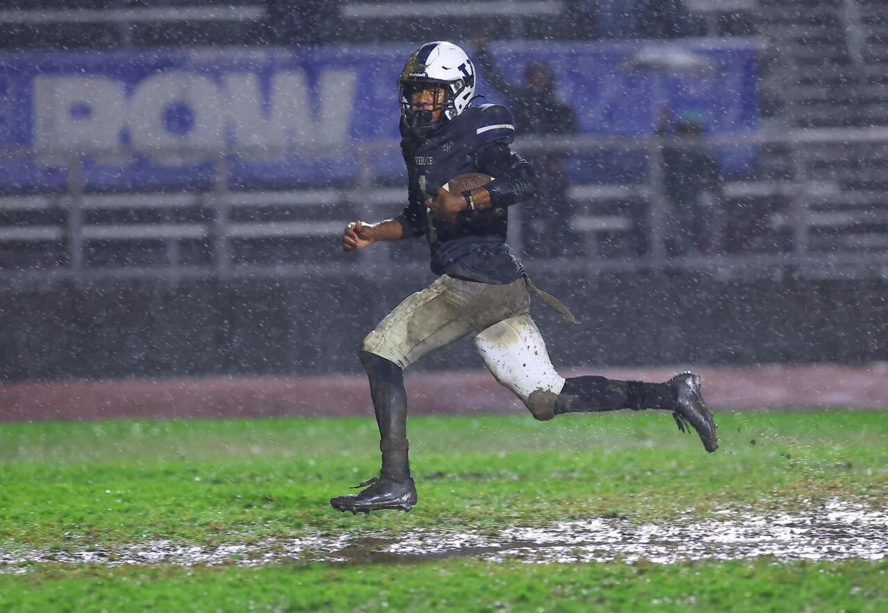 Santa Margarita football coach Carson Palmer held up well in the rain.